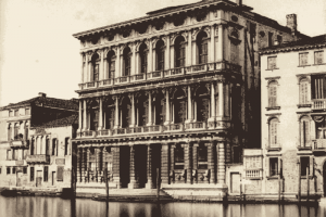 A historic photograph of the Palazzo Rezzonico by the Grand Canal.