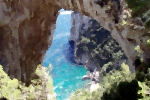 A rocky arch overlooking a small bay in Capri.