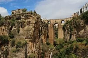 A view of some cliffs and famous Puente Nuevo Bridge in Ronda, Spain.
